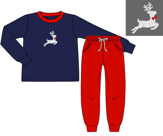 Children's navy blue long-sleeve top and red pants with a reindeer design on a white background.