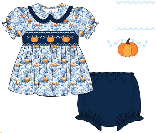 Children's dress with pumpkin pattern and matching bloomers on a white background
