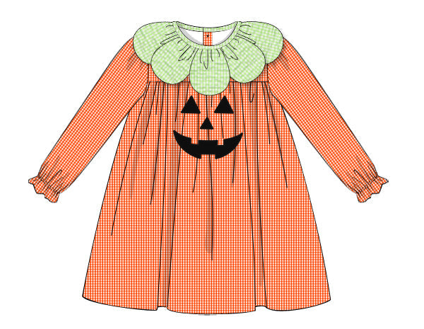 Children's dress with pumpkin face design on a white background
