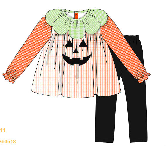 Children's Halloween outfit with orange checkered top and black pants on a white background